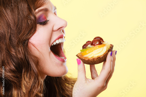 Closeup woman eating fruit cake sweet food