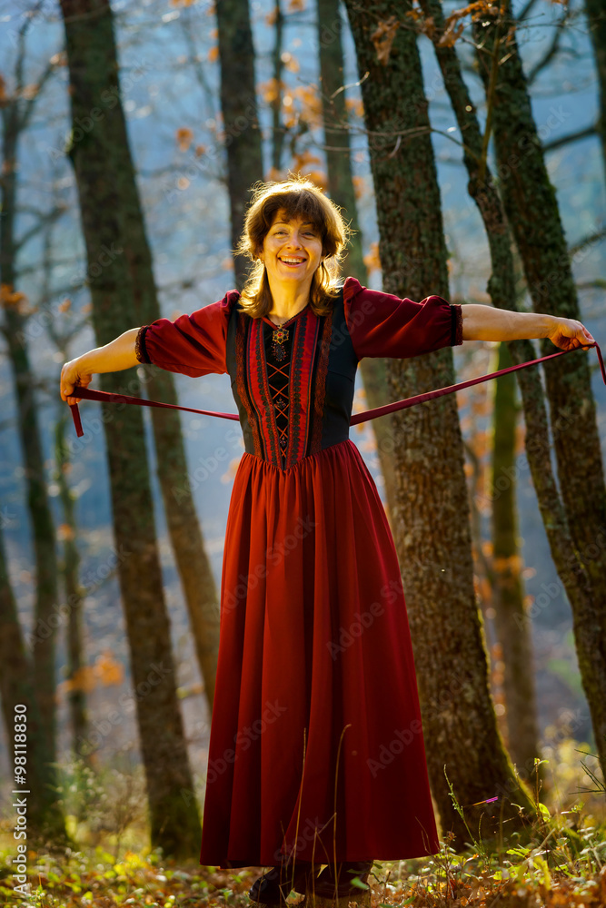 Woman in red dress portrait, autumnal forest Woman in red dress portrait, autumnal forest