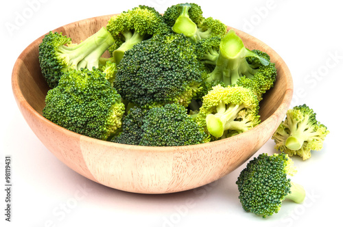 Isolated broccoli in wooden bowl over white background