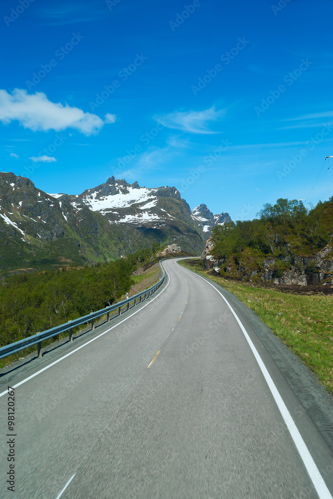 Asphalt road on Norvegian mountains in sunny clear day Asphalt road on Norvegian mountains in sunny clear day