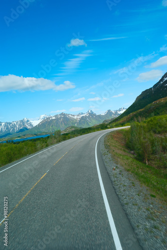 Asphalt road to Norvegian mountains in summer clear day