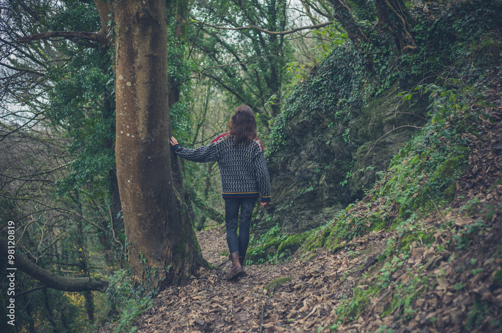 Young woman leaning on tree in forest Young woman leaning on tree in forest