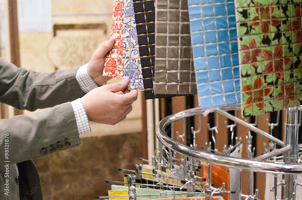 Closeup picture on hands choosing or presenting colorful samples