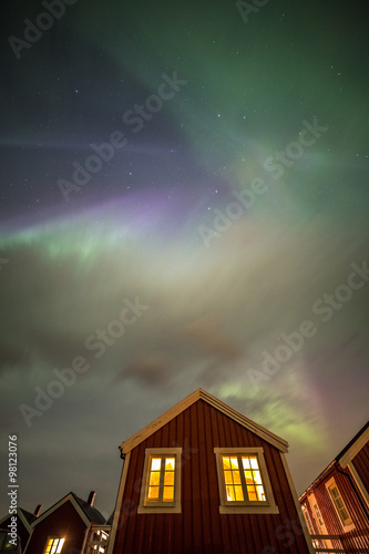 Aurora borealis above rorbuer in Hamnoy village, Lofoten, Norway