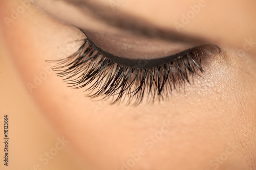 closeup of made-up female eye with artificial eyelashes