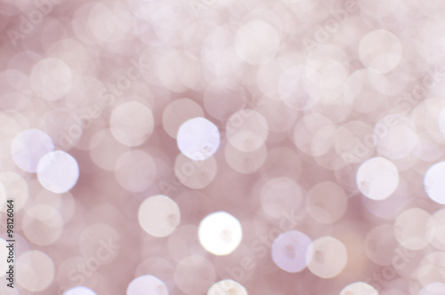 Light blurred background with white bokeh lights on it. Festive holiday theme with copyspace