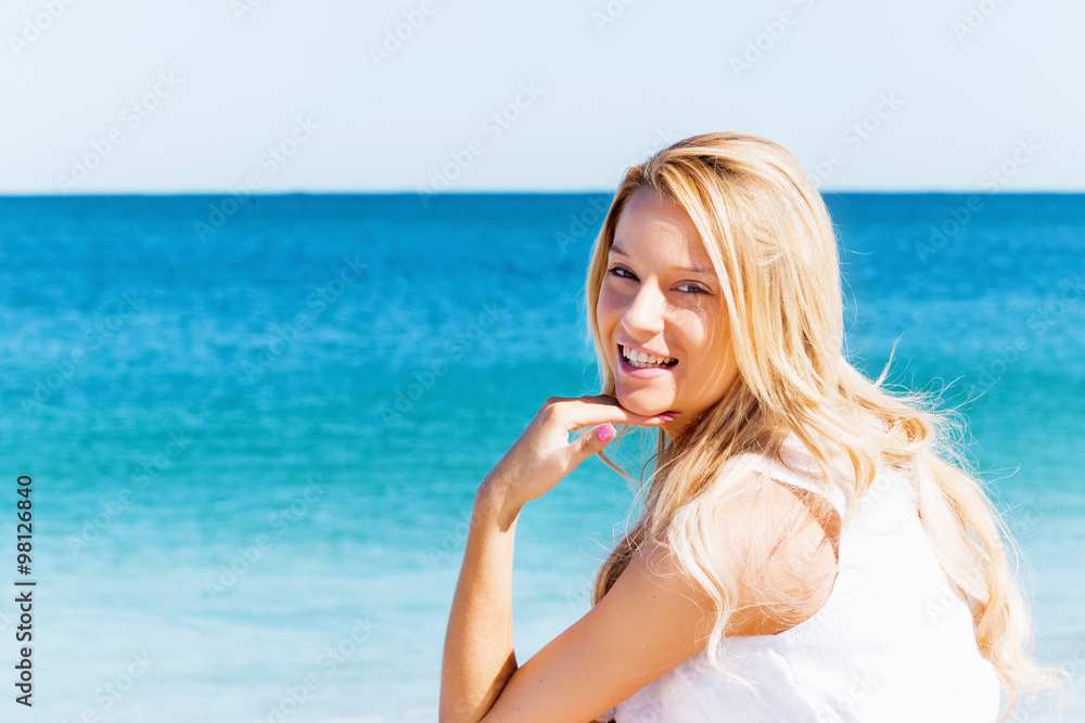Young woman relaxing on the beach Young woman relaxing on the beach