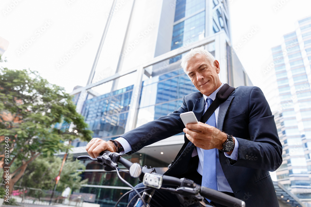 Successful businessman riding bicycle Successful businessman riding bicycle