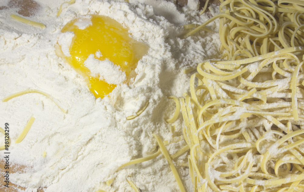 Asian Noodle and Egg with Flour on Wooden Table Closeup Asian Noodle and Egg with Flour on Wooden Table Closeup