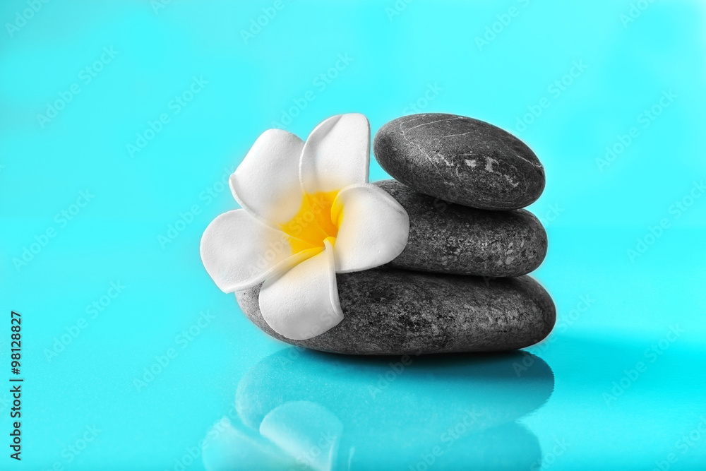 Spa stones and flower on blue background Spa stones and flower on blue background