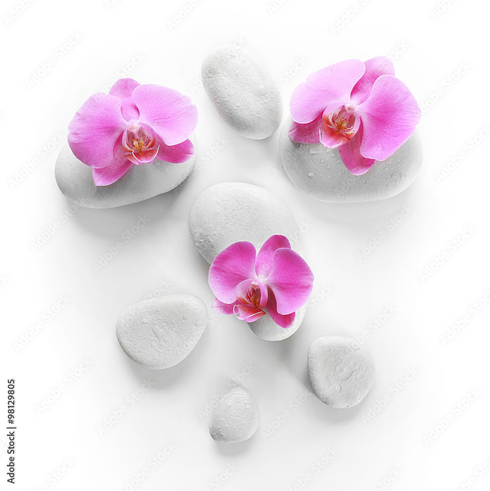 White spa stones and orchids isolated on white White spa stones and orchids isolated on white
