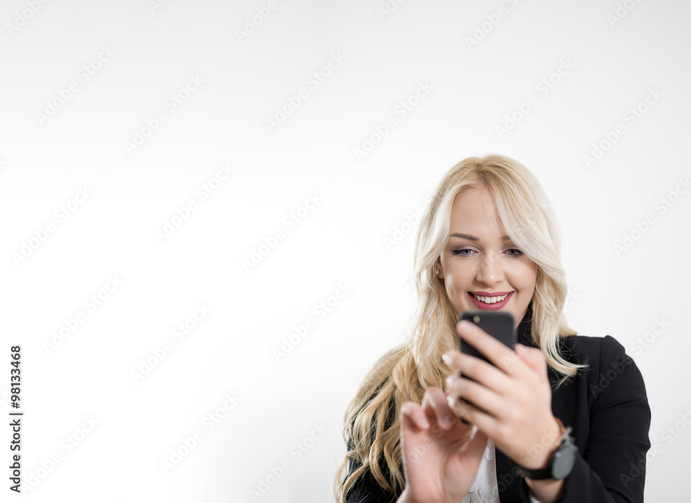 Examining her brand new smart phone. Beautiful young blond hair Examining her brand new smart phone. Beautiful young blond hair