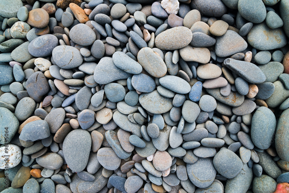 Beach pebbles stones smooth background mixed colorurs and shapes Beach pebbles stones smooth background mixed colorurs and shapes