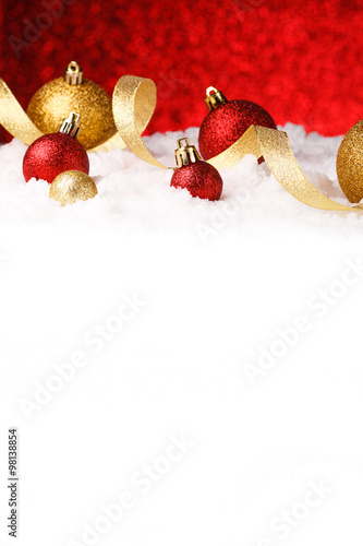 christmas ornament in snow on glitter background
