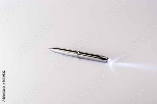 Modern silver pen with torch light.