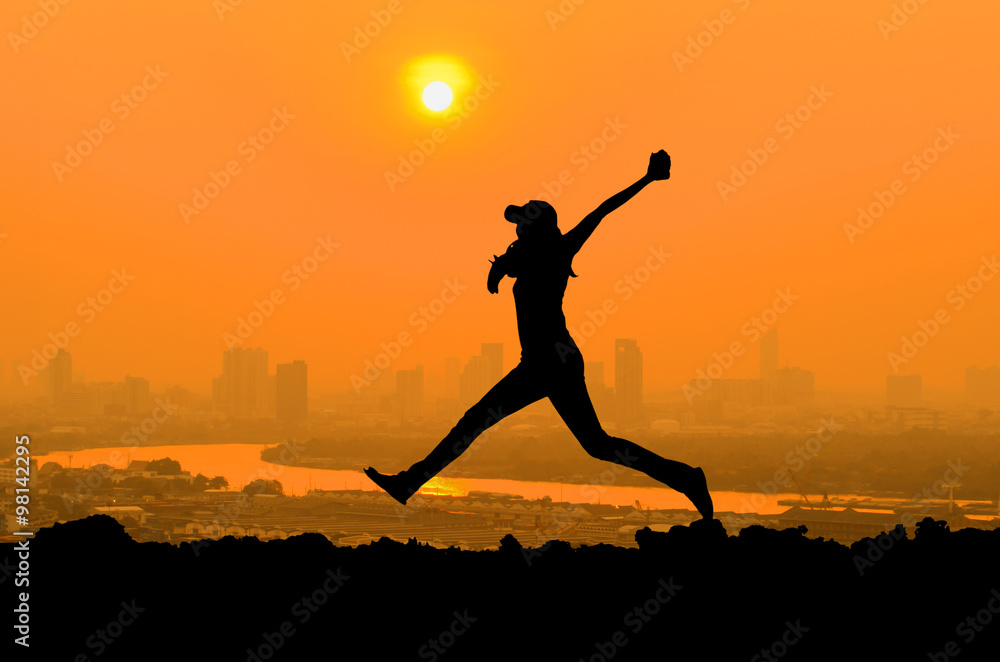 silhouette of woman jumping when happy