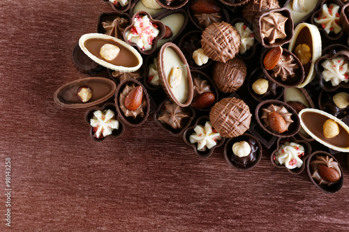 Appetizer chocolate candies on wooden background