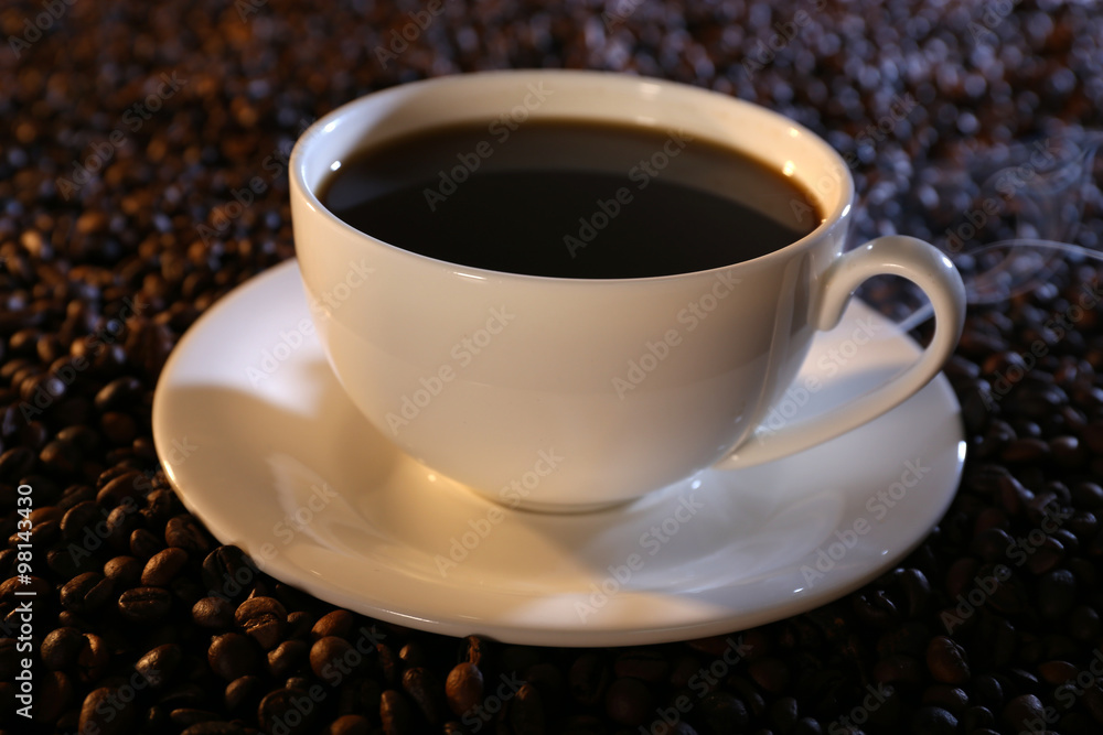 Cup of hot coffee on coffee beans background Cup of hot coffee on coffee beans background