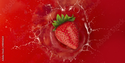 strawberry splash into red juice liquid