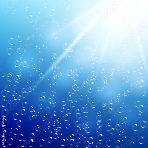 Water background with air bubbles and sunlight