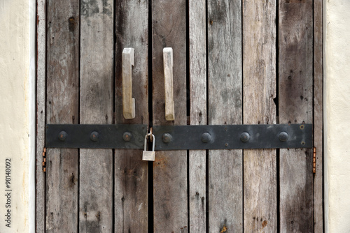 Rustic old plank door with lock © isweetynat