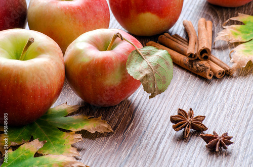 Apples with leaves, cinnamon sticks, star anise and autumn leave