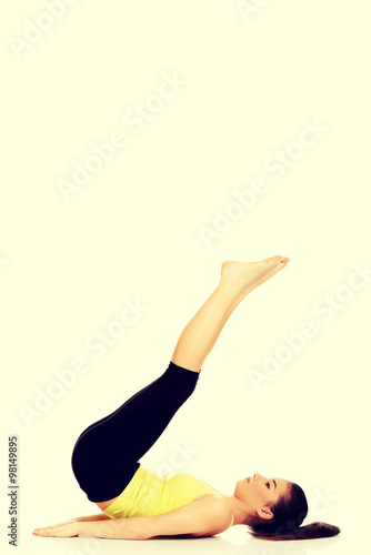 Fitness woman with her legs up.