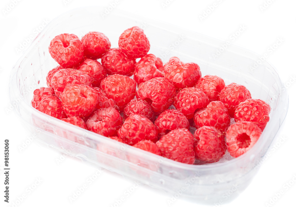 raspberries in a plastic tray isolated on a white background raspberries in a plastic tray isolated on a white background