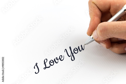 Hand writing "I Love You" on white sheet of paper.