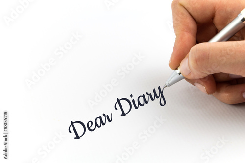 Hand writing "Dear Diary" on white sheet of paper.
