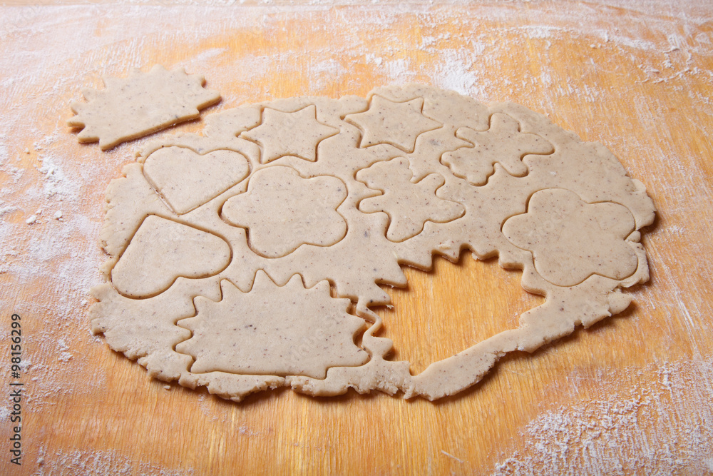 Dough for gingerbread cookie and cookie cutted in different shap Dough for gingerbread cookie and cookie cutted in different shap