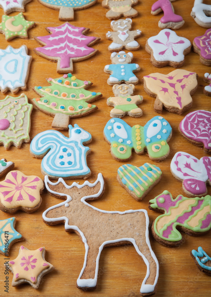 Gingerbread homemade cookies with icing colored drawings on wood Gingerbread homemade cookies with icing colored drawings on wood