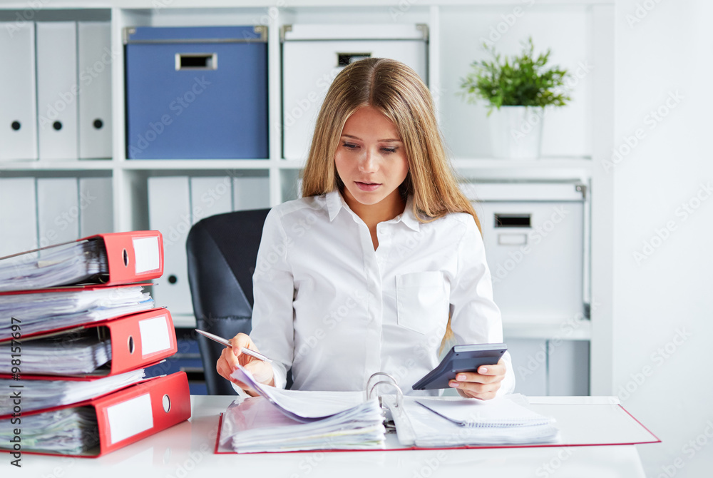 Business woman calculates tax Business woman calculates tax