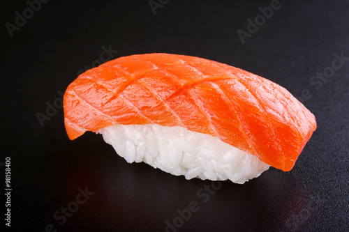 Nigiri sushi with salmon on black background