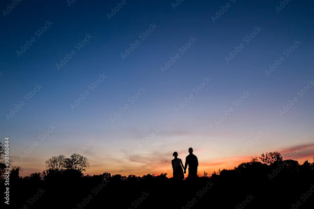 Couple in love walking at sunset.