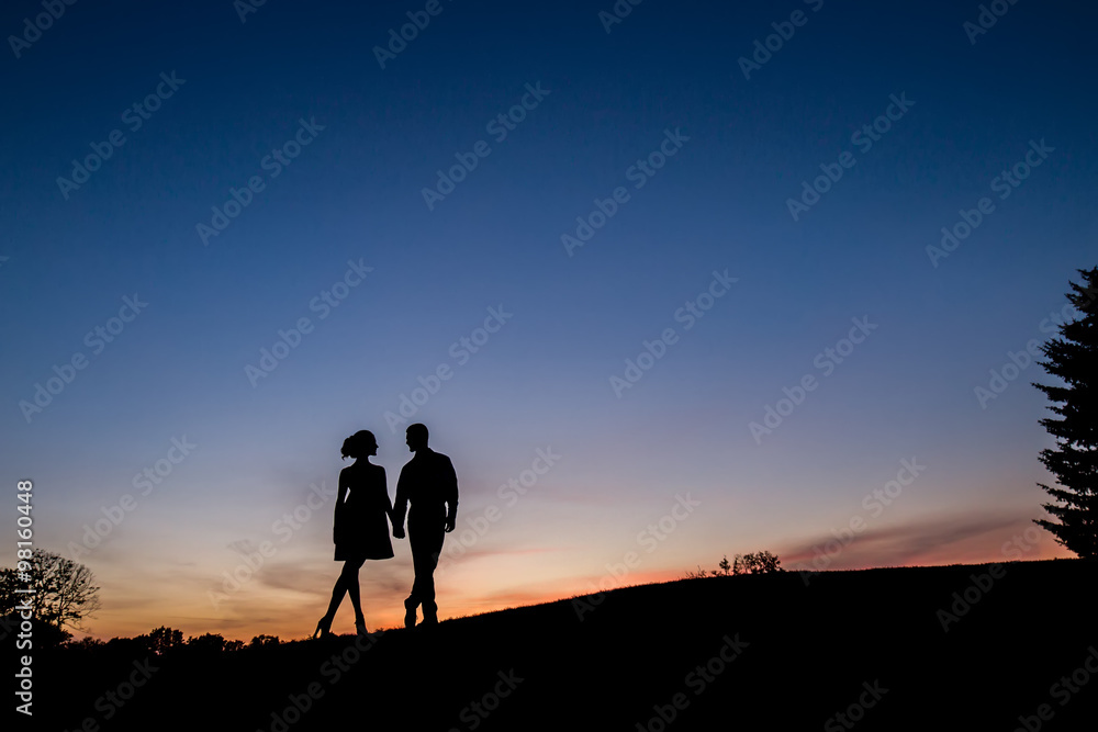 Lovers on sunset background.