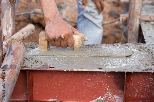 plasterer concrete worker at beam being constructed