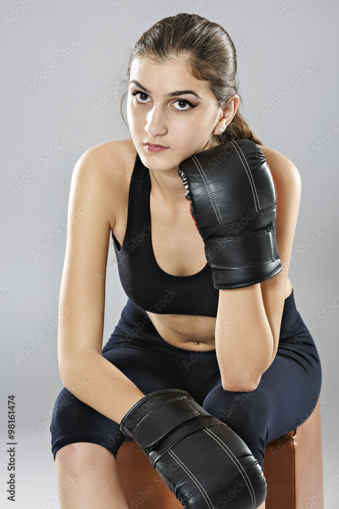 sport young woman boxing gloves, face of fitness girl studio sho