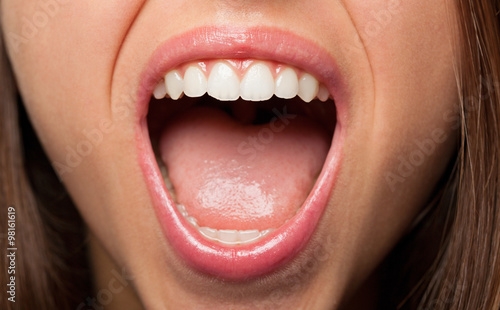 A young pretty woman teeth extreme closeup photo