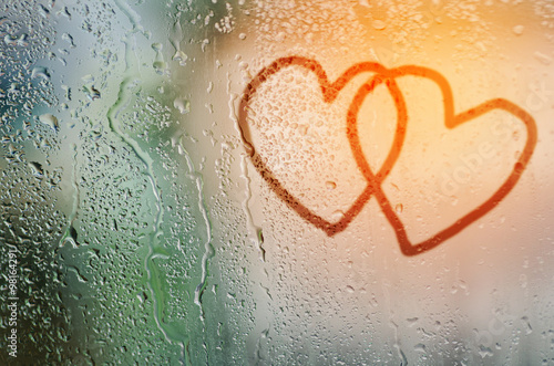 draw cople heart on natural water drops glass window background photo