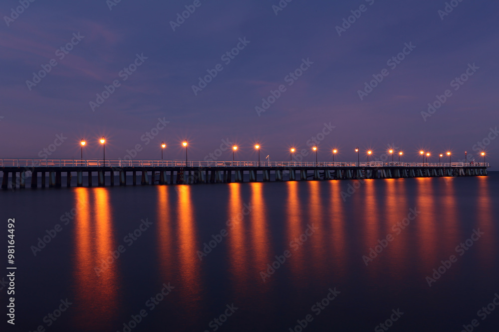The longest pier in Poland. Misty pier at night. Colorful night on pier.
