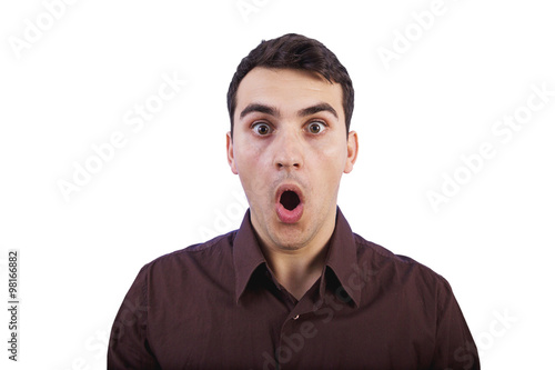 Surprised young man with open mouth studio portrait over whit background.Shocked young man.