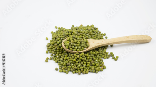 Mung beans over wooden spoon on white background