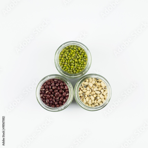Black eye peas  mung bean and adzuki beans in a mason jar over white background