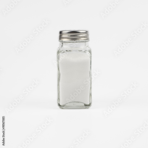 Glass salt shakers on white background
