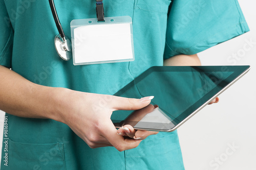 Female doctor at hospital working on a digital tablet  photo