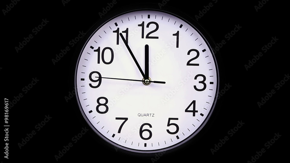 Wall clock on a black background 23:55 hours Wall clock on a black background 23:55 hours