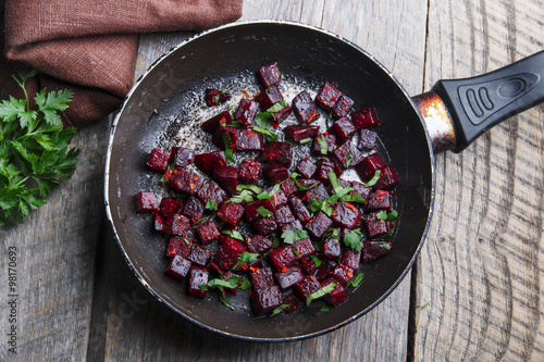 Cooked beets sliced and fried in a pan photo