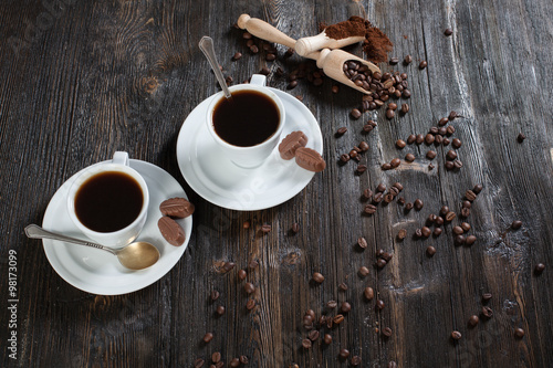 coffee cup background with coffee beans and chocolate candies