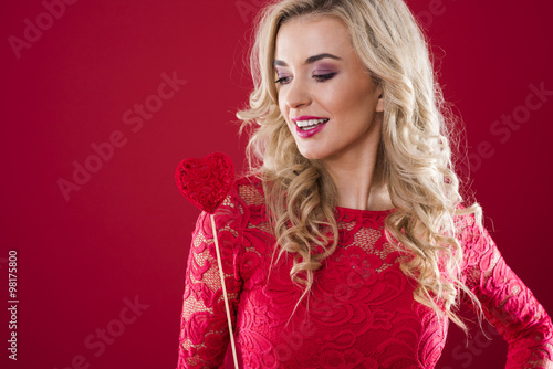 Woman looking at stick with felt heart